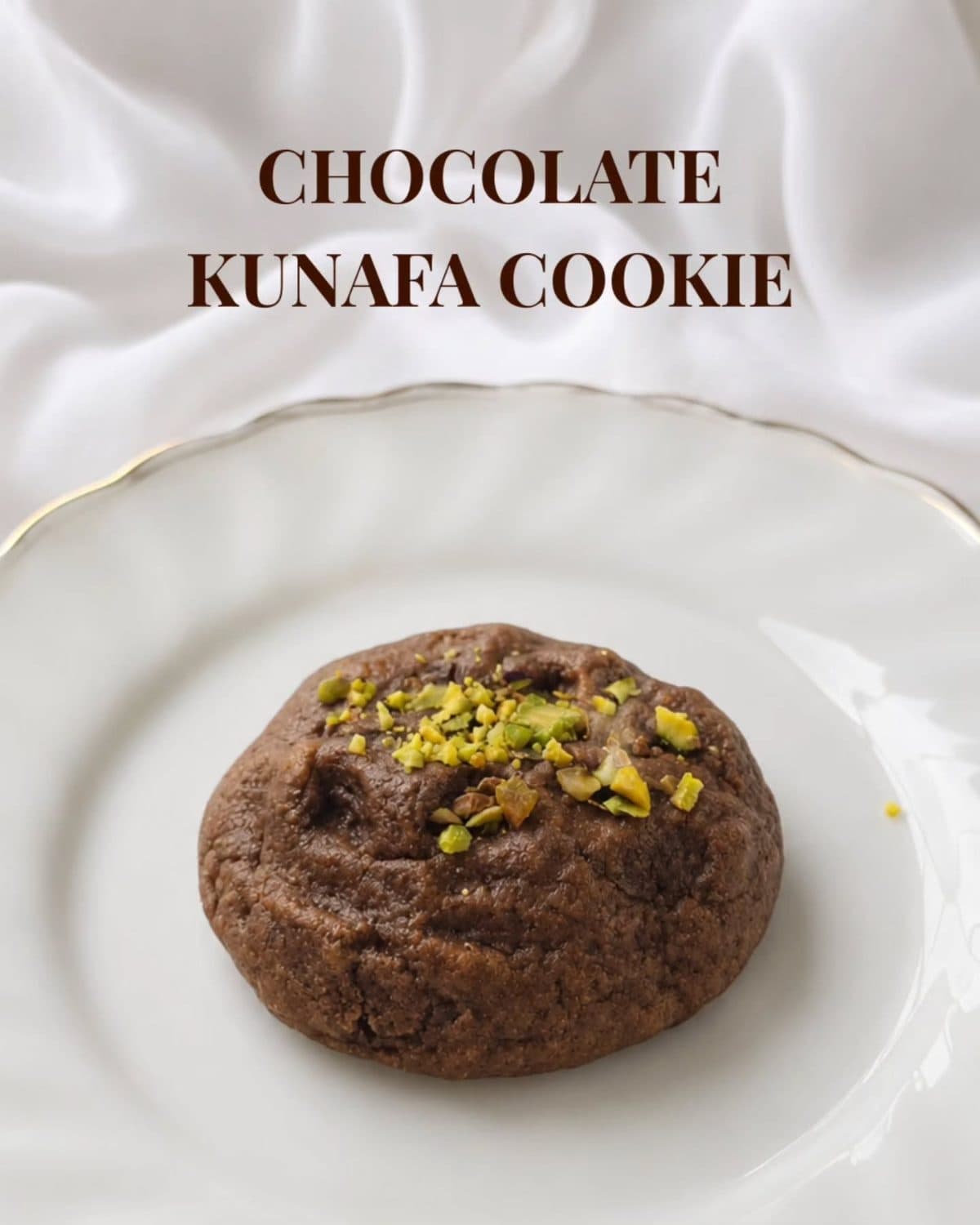 Chocolate kunafa cookie topped with pistachio on a plate